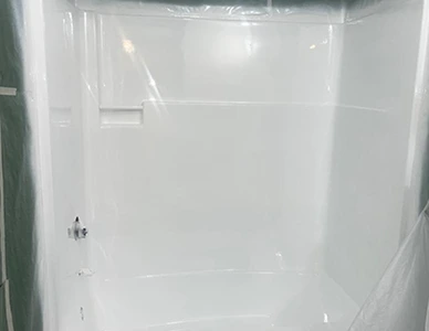 Refinished shower stall after professional reglazing with glossy clean surface