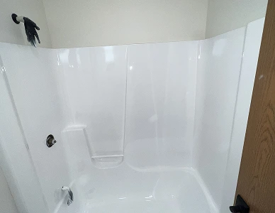 Shower after reglazing – bright white smooth finish restored.
