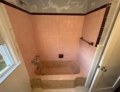 Bathroom tiles before refinishing with dull and stained surface