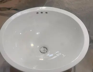 Bathroom sink after reglazing with smooth glossy finish