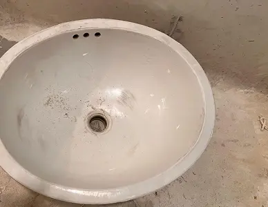 Bathroom sink before reglazing with dull, worn surface