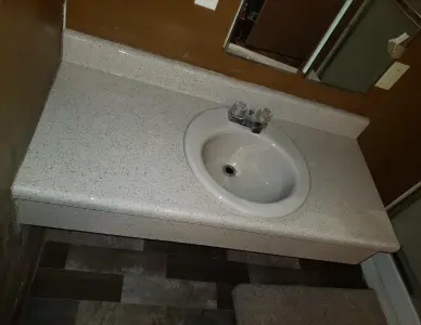 Vanity sink after resurfacing featuring a polished clean surface