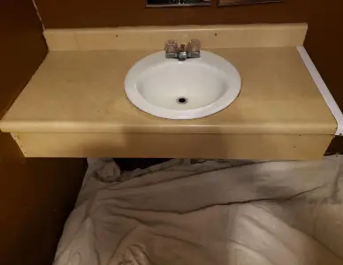 Bathroom vanity sink before resurfacing with chipped coating