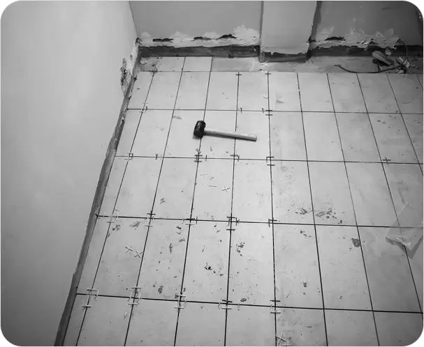 Bathroom tile regrouting with renewed bright white grout finish